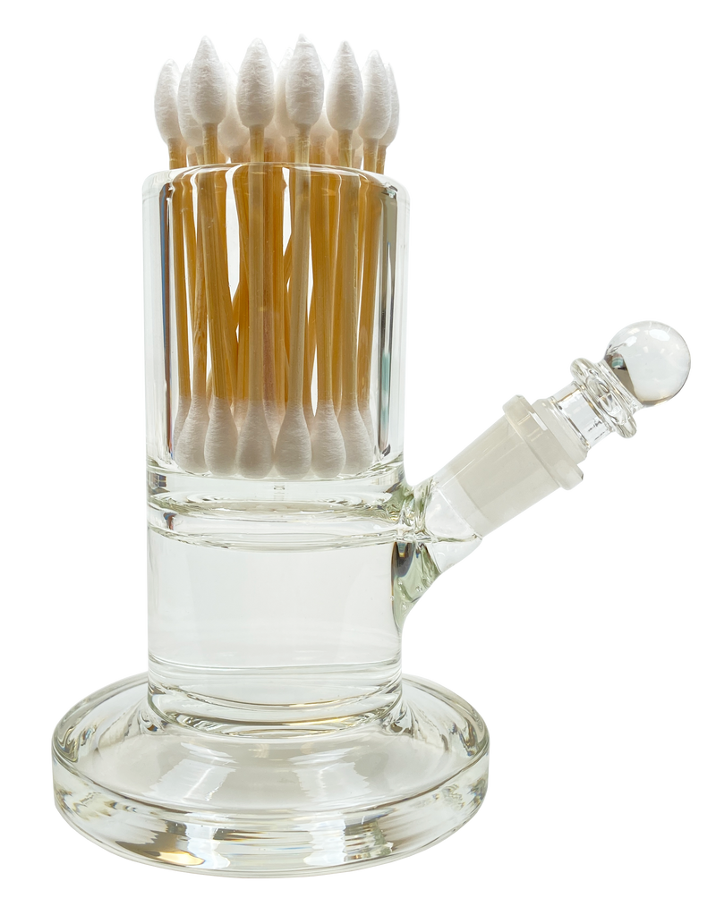 Our clear glass dab rig cleaning station stores swabs in an easy to access holder that is positioned atop the large alcohol chamber. An angled glass spout makes it easy to reach the ISO and easy to refill. The glass stopper prevents evaporation.
